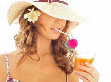  A young and sexy lady in swimsuit and hat under drinking juice on a hot day