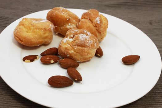 fresh tasty brewing cake with almond on the white plate