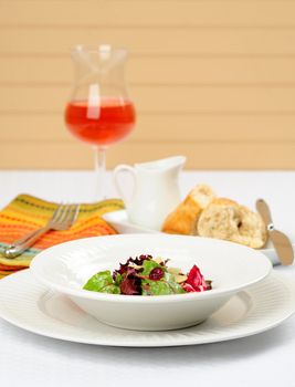 Delicious appetizer salad of fresh greens and dried cranberries.