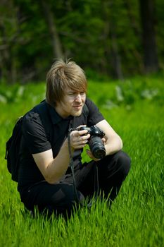 Photographer on a green field