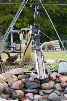 An old fashioned water pump and trough.