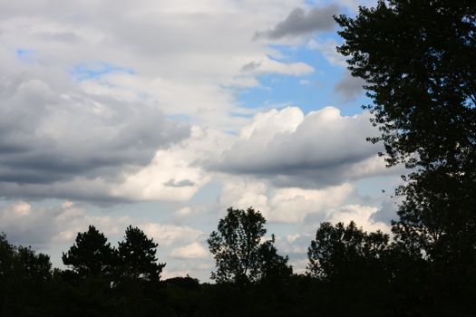 Trees boarder the scene with clouds in the background.