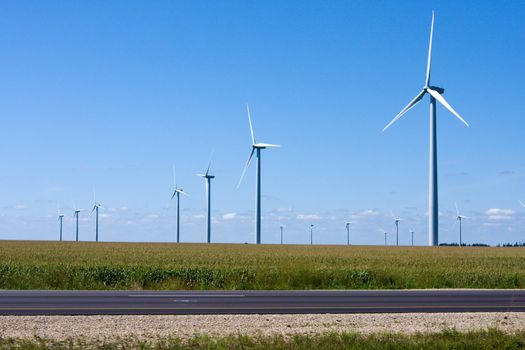 Modern Windmills generating electricity along the Interstate.