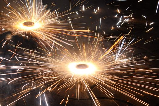 A type of firework/cracker rotating on the ground, during the Diwali festival celebrations in India.