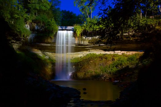 Beautiful Minneapolis waterfall under the lights early in the morning.