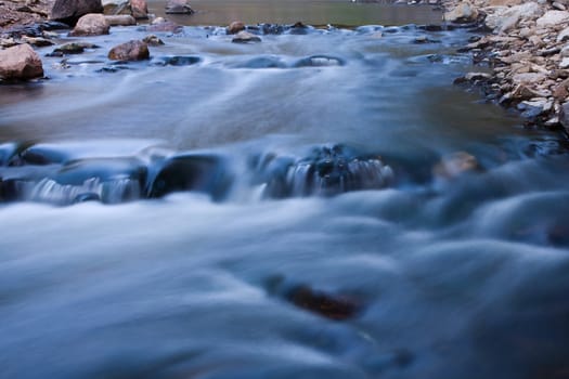 Rapids Running Fast on a bend at a river.