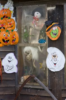 Haunted house window with creepy figures staring out.