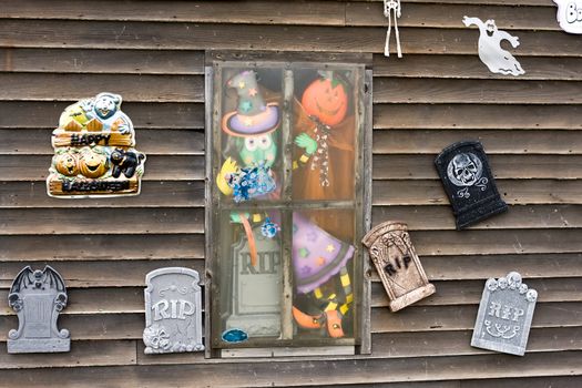 Haunted house window with creepy figures staring out.