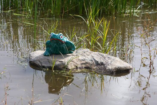 A Ceramic Frog watching over it's home.