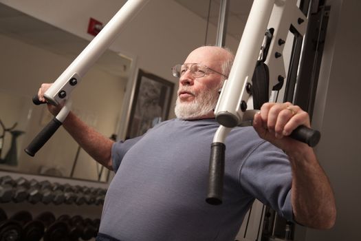 Active Senior Adult Man Working Out in the Gym.
