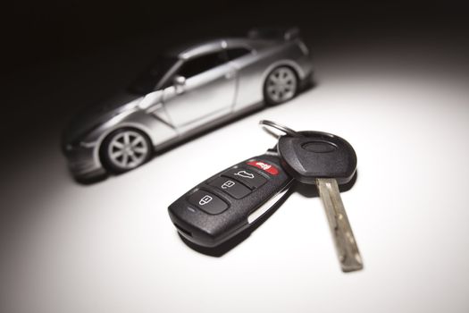 Car Key, Remote and Sports Car Under Spot Light.