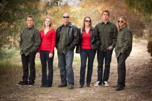 Happy Attractive Family Standing Portrait Outdoors.