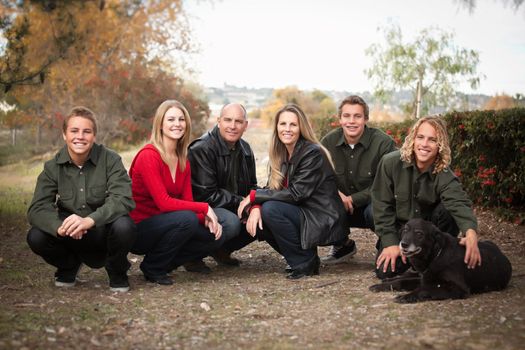 Happy, Attractive Family Pose for a Portrait Outdoors.