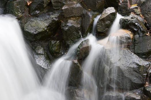 Neat looking rocks with smooth water running over them.