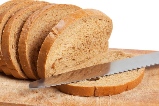 Bread slices and knife on a cutting board isolated over white