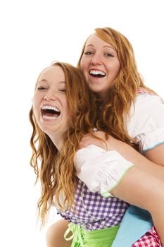 two bavarian dressed girls having fun on white background