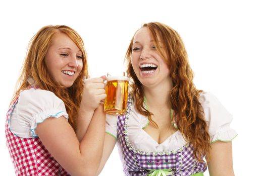 two bavarian girls cheering with beer on white background