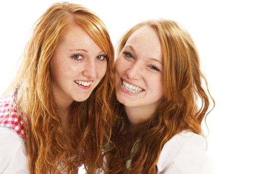 two happy redhead bavarian dressed girls on white background