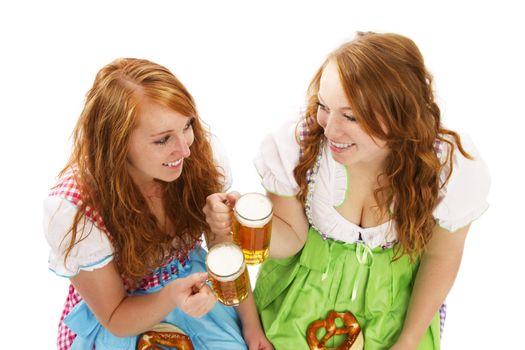 two bavarian women with beer and pretzels on white background