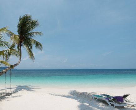 Paradise beach in Rawa island in Malaysia with hanging rope and relax chairs