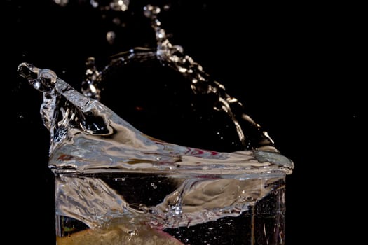 The motion of a slice of apple splashing into a glass of water