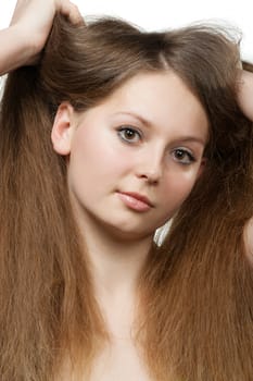 The beautiful girl with long healthy hair. It is isolated on a white background