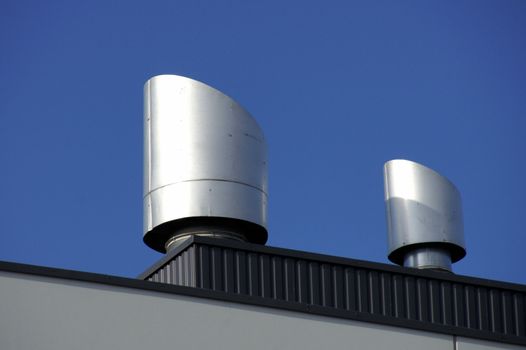 Vents of ventilation are located on a roof of a  building