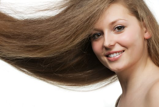 Healthy beautiful long hair closeup in motion created by wind. Portrait