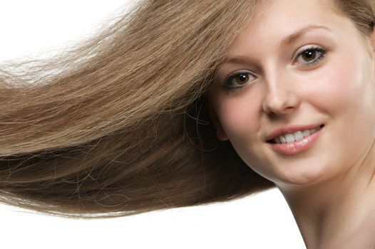 Healthy beautiful long hair closeup in motion created by wind. Portrait