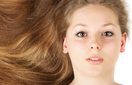 Healthy beautiful long hair closeup in motion created by wind. Isolated on white