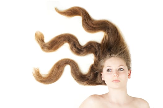 Healthy beautiful long hair closeup in motion created by wind. Isolated on white