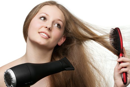 The girl with long hair does to itself a hairdress. It is isolated on a white background