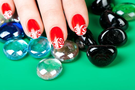 Female hands with French manicure. It is isolated on a green background
