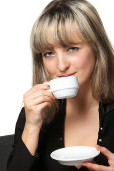 The business woman drinks coffee on the workplace. It is isolated on the white background.