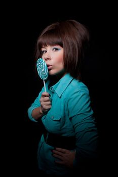 young woman with lolipop, black background