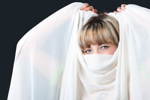 The woman close up. Face partially covered pareo.