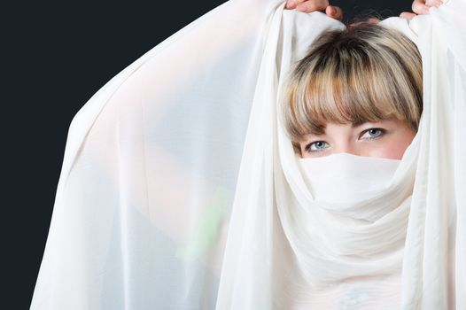 The woman close up. Face partially covered pareo.