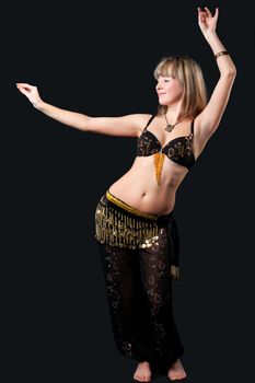 The woman in east dancing suit. Isolated on black background