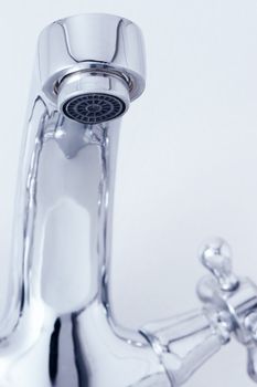 tap with drop water. Cold toned image. Closeup
