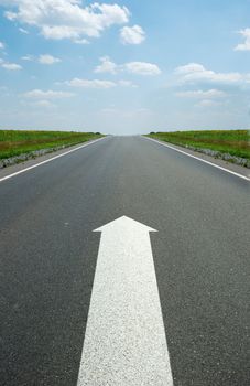 road marking arrow. White arrow at detailed texture asphalt
