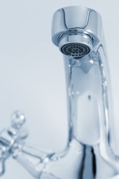 tap with drop water. Cold toned image. Closeup