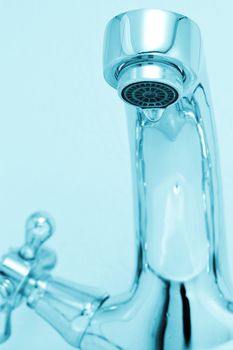 tap with drop water. Cold toned image. Closeup