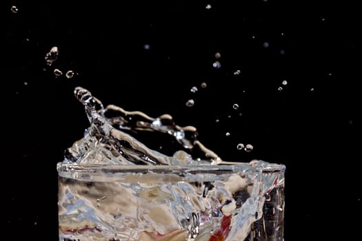 The motion of a slice of apple splashing into a glass of water