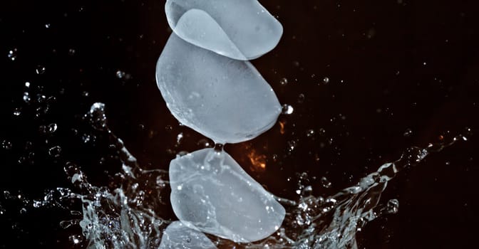 The motion of ice splashing into a glass of water frozen in time