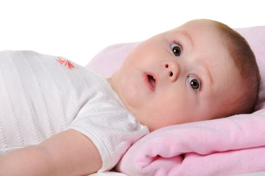 The baby lays. Age of 8 months. It is isolated on a white background