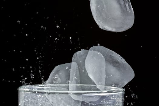 The motion of ice splashing into a glass of water frozen in time