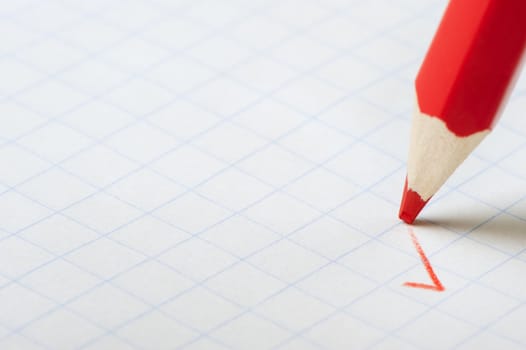 Red pencil writing a mark. Abstract concept