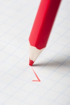 Red pencil writing a mark. Abstract concept