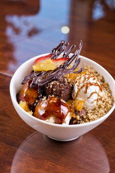 ice cream with chocolate, nuts and caramel close up