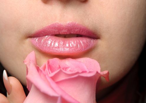 The woman with a rose. A photo close up parts of the person and a flower
